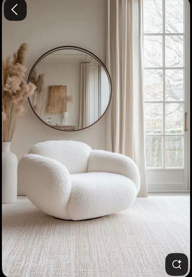 A contemporary white lounge chair upholstered in a textured boucle fabric, featuring a rounded, sculptural, and legless design. — 3D model