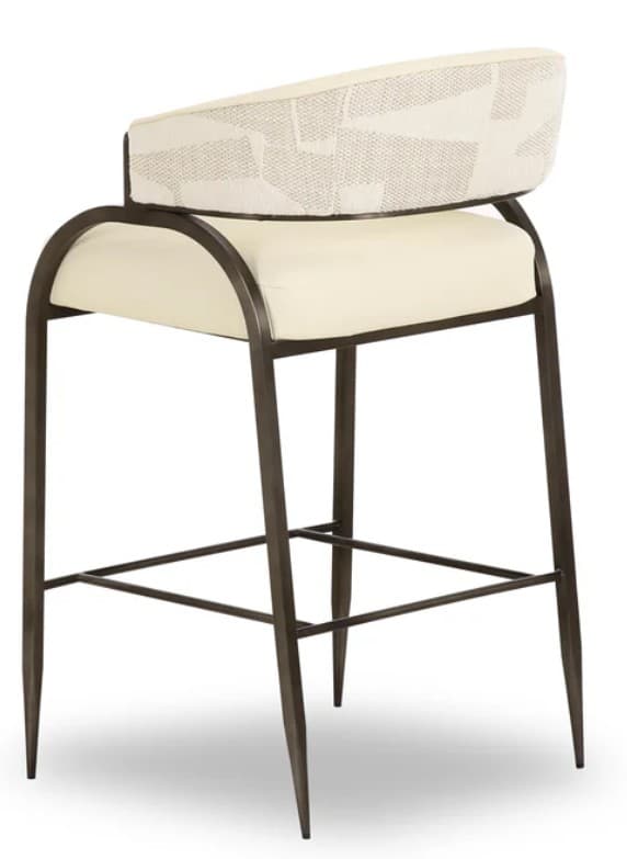 A bar stool with a curved backrest and a padded seat. The frame is constructed from dark metal with tapered legs and a footrest connecting the legs. The seat is upholstered in a cream-colored material, and the backrest features a patterned fabric in off-white and grey tones. — 3D model