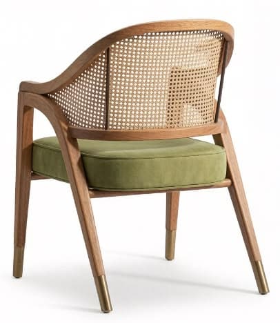 A contemporary armchair featuring a light-toned wooden frame with a curved cane webbing backrest and a square upholstered seat cushion. The chair has integrated wooden armrests that flow into the legs. The four tapered wooden legs are capped with brass or gold-toned metal ferrules. — 3D model