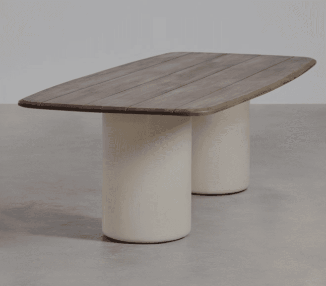 A modern rectangular dining table featuring a slatted wood tabletop with rounded corners, supported by two cylindrical pedestal bases in a contrasting off-white finish. — 3D model