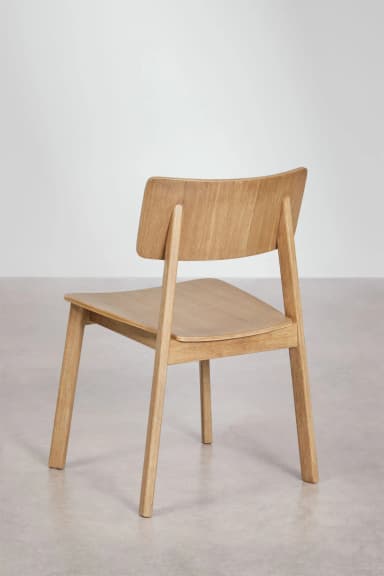 A modern, minimalist side chair constructed from light-colored solid wood, featuring a flat seat and a curved backrest attached to the rear legs. — 3D model