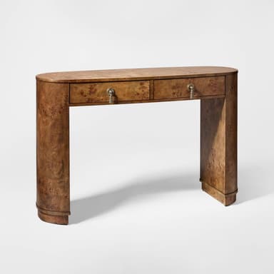 An elongated Art Deco or Streamline Moderne console table crafted from richly figured burl wood veneer. It features a rounded, oval-shaped top that seamlessly transitions into two curved, solid legs, creating a waterfall effect. The front apron includes two shallow drawers, each with a decorative metal pull and a tassel. — 3D model