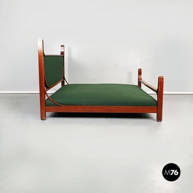 A daybed with a wooden frame and a green upholstered mattress. The frame has a rectangular base with two vertical supports at the head and a single vertical support at the foot. The headboard is curved and upholstered in green fabric. The armrests are integrated into the frame and extend from the headboard supports. — 3D model