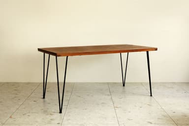 A rectangular coffee table featuring a top constructed from uniformly spaced wooden slats, supported by four slender black metal hairpin legs. — 3D model