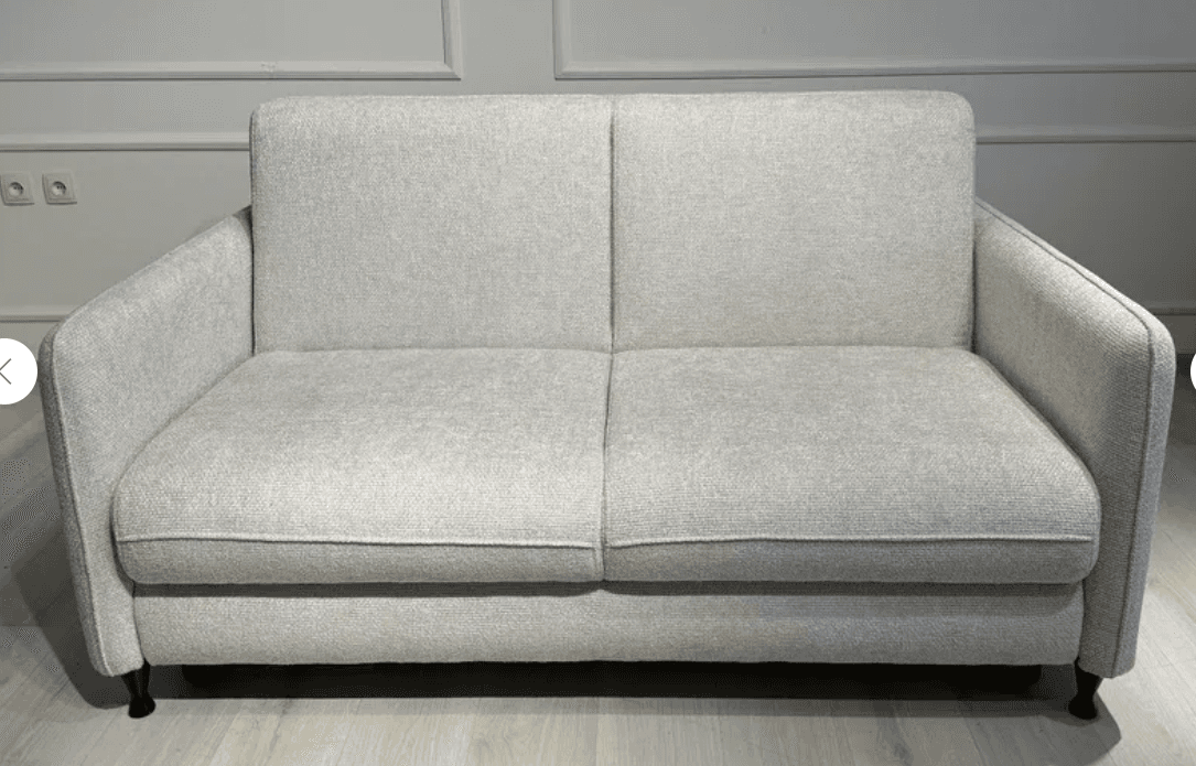 A modern two-seater sofa, also known as a loveseat, upholstered in a light gray textured fabric, featuring clean lines, removable back and seat cushions, and supported by small, dark, tapered legs. — 3D model