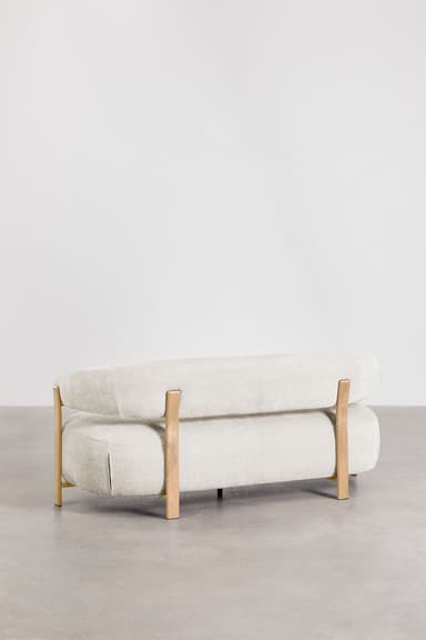 A contemporary sofa with a curved, organic shape. It features a thick, upholstered seat and backrest with rounded edges. The frame is partially exposed, with light-colored wooden legs and armrest supports that extend upward. The upholstery appears to be a textured fabric. — 3D model