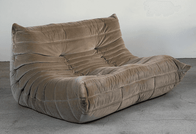 A low-profile, two-seater sofa with a distinctive all-foam construction and an ergonomic design, upholstered in a plush, taupe-colored velvet fabric with a gathered, pleated, and tufted appearance. — 3D model