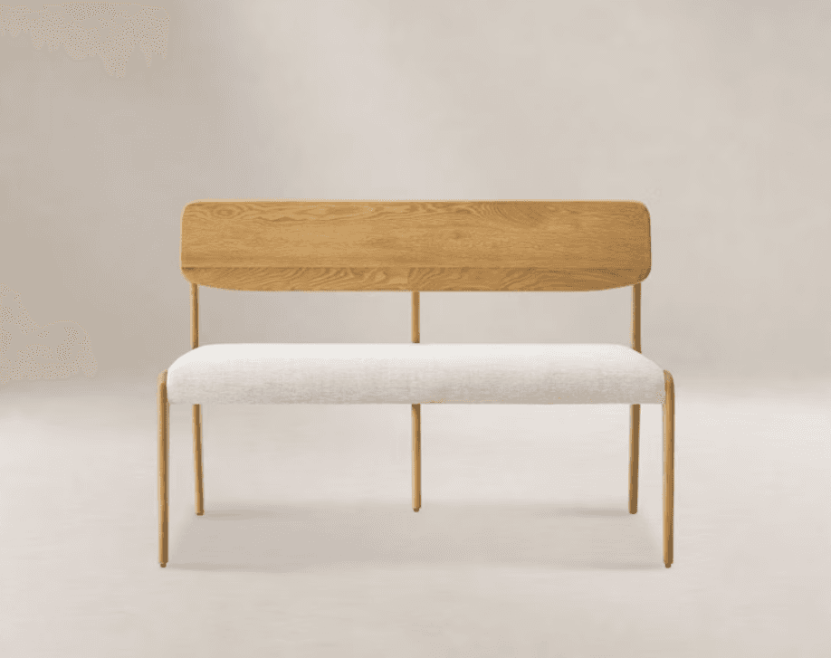 A modern and minimalist two-seater bench featuring a natural oak wood backrest and a light-colored fabric upholstered seat, supported by a slender, round-legged wooden frame. — 3D model