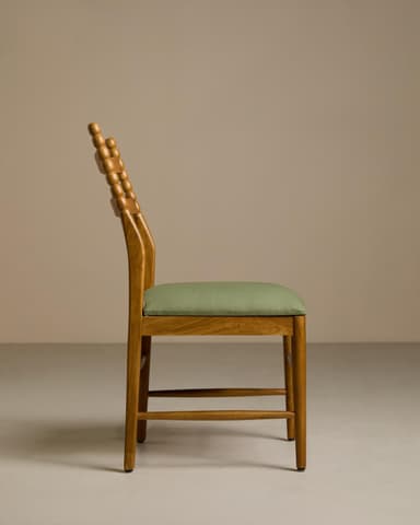 A wooden dining chair with a light natural wood finish and an upholstered green seat cushion. The chair features a backrest with two horizontal slats and vertical back posts adorned with a beaded, turned detail. The legs are straight and connected by simple stretchers, providing stability. — 3D model