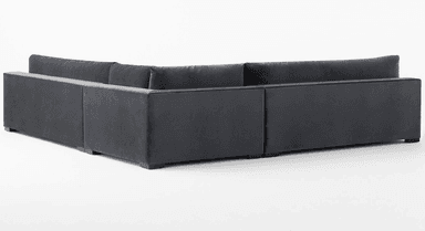 A deep-seated, modular sectional sofa with a low profile and plush cushioning. The sofa features a dark gray, velvet-like upholstery and a clean-lined, contemporary design. It is configured in an L-shape, suggesting a chaise lounge component on the right side. — 3D model
