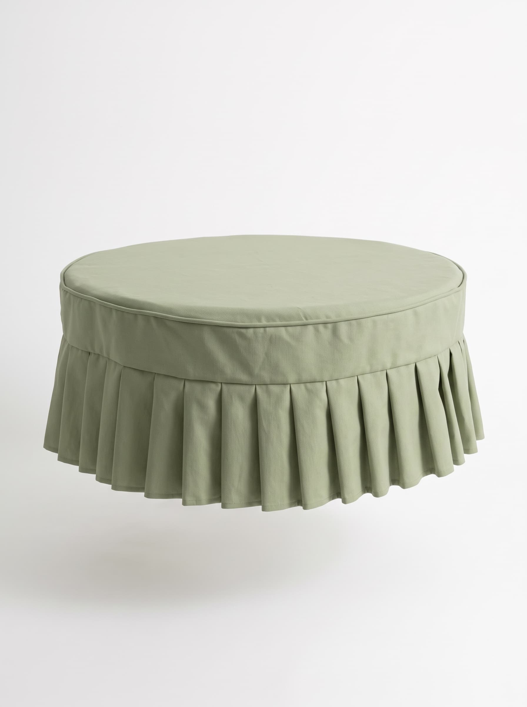 A round, light green upholstered ottoman featuring a pleated skirt base and a flat cushioned top. — 3D model