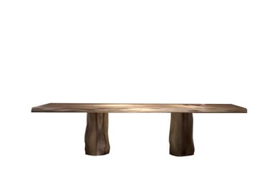 A long, rectangular wooden bench featuring a live-edge top and two thick, organically shaped wooden pedestal legs. The natural wood exhibits prominent grain patterns. — 3D model