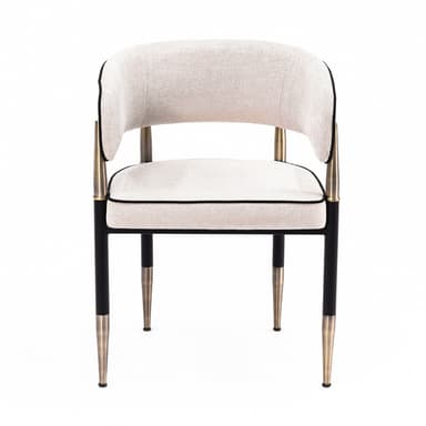 A contemporary upholstered armchair featuring a curved barrel back and seat, covered in a light beige textured fabric with distinct black piping. The chair is supported by a black metal frame with elegant brass accents on the integrated armrests and tapered leg tips. — 3D model