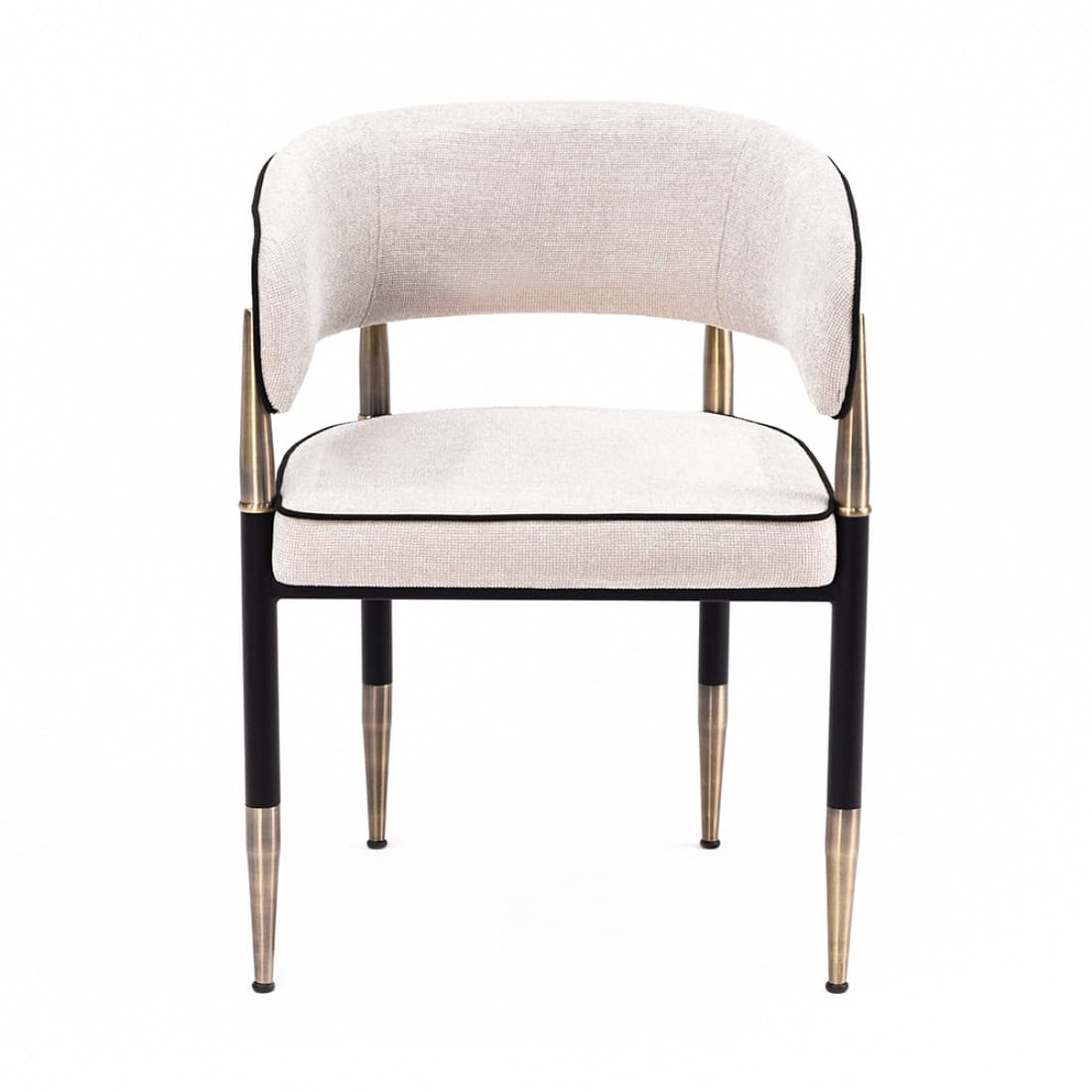 A contemporary upholstered armchair featuring a curved barrel back and seat, covered in a light beige textured fabric with distinct black piping. The chair is supported by a black metal frame with elegant brass accents on the integrated armrests and tapered leg tips. — 3D model