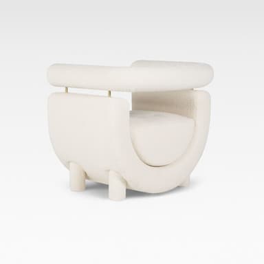 A contemporary cream-colored accent chair featuring a distinctive U-shaped upholstered body with a separate, cylindrical backrest/armrest element supported by thin brass rods. The chair is upholstered in a soft boucle fabric and stands on short, cylindrical upholstered legs. — 3D model
