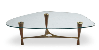 A glass-top coffee table with a distinctive mid-century modern design, featuring a sculptural brass frame and tapered wooden legs. — 3D model