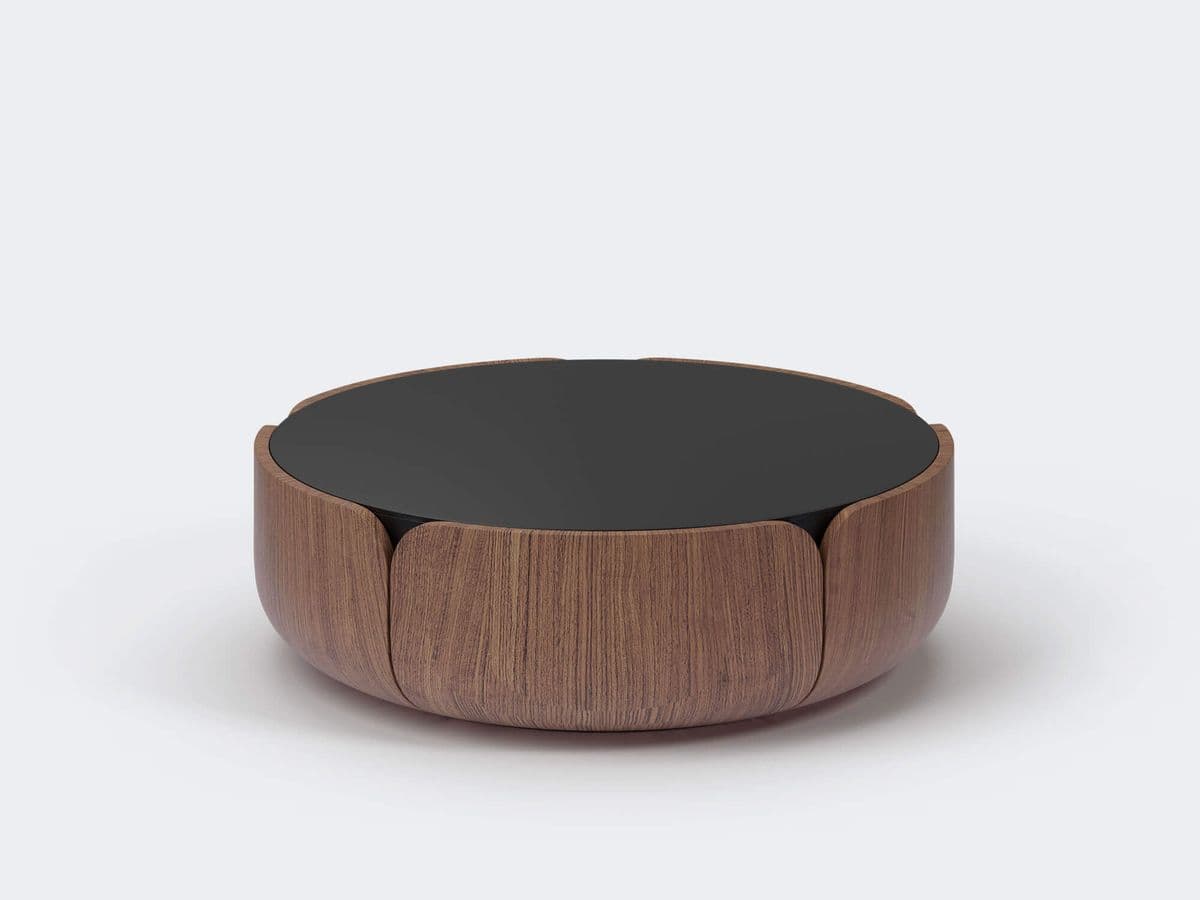 A round coffee table with a dark, possibly glass or lacquered, top. The base is constructed from curved wooden panels with a visible wood grain pattern, arranged in a way that resembles petals opening outwards. The overall design is contemporary and organic. — 3D model