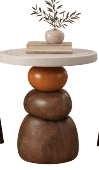 A contemporary accent table featuring a round, light-colored top resting on a distinctive sculptural base. The base is composed of three stacked, organically shaped elements: an orange sphere at the top, followed by two progressively larger, dark wood, pebble-like forms. — 3D model