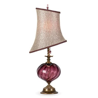 An ornate table lamp featuring a twisted, swirled purple glass body, an antiqued brass base and neck, and a unique angled fabric lampshade. The shade has a textured, possibly animal-print or distressed pattern, trimmed with a decorative border and topped with a small finial adorned with beads. The overall aesthetic is elaborate and decorative. — 3D model