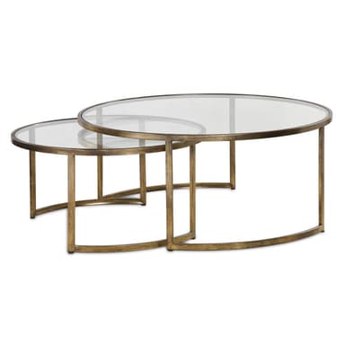 A set of two oval nesting coffee tables featuring amber-tinted glass tops and distressed gold-finished metal frames. The larger table is an elongated oval, and the smaller table is a slightly more compact oval, designed to partially slide under the larger one. The metal frames are slender with a brushed or aged appearance, forming a sturdy base for the glass tops. — 3D model