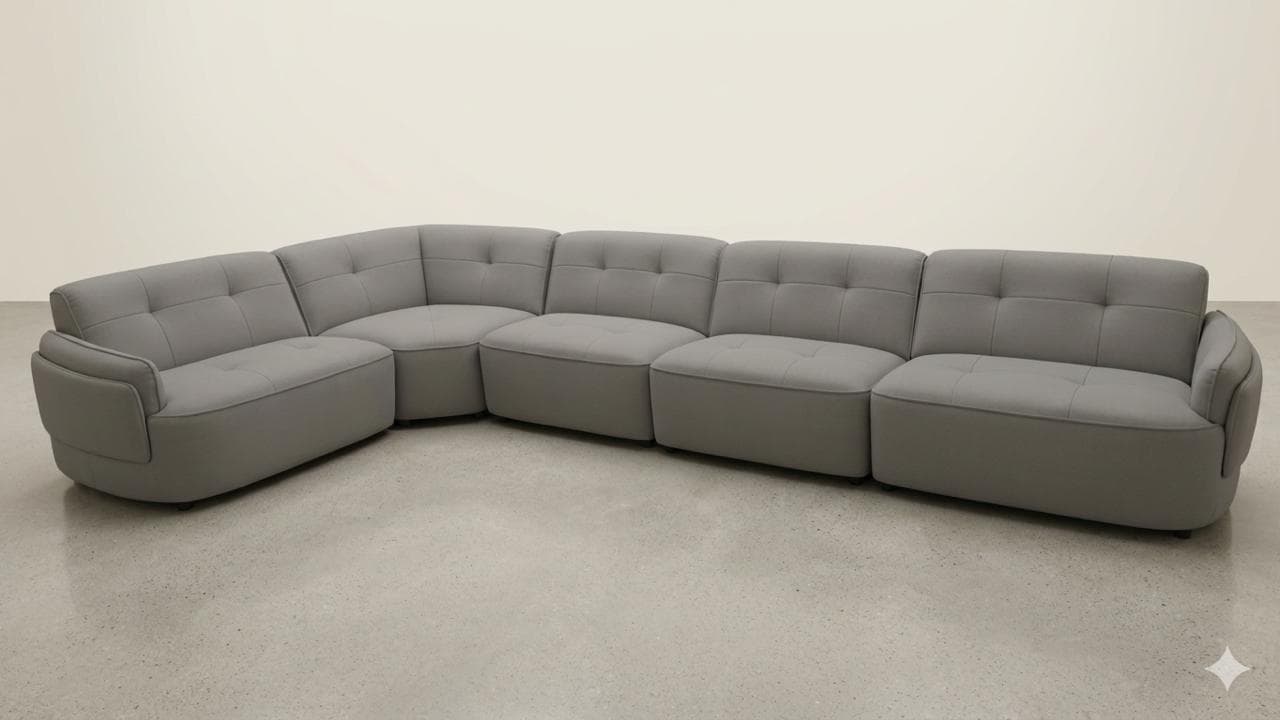 A modular sectional sofa with a curved configuration, upholstered in a grey fabric. The sofa consists of multiple individual seating units that connect to form a larger seating arrangement. Each seat cushion and backrest features a tufted design with a grid pattern created by stitching. The sofa has rounded edges and a low profile, with broad armrests on the leftmost section. — 3D model