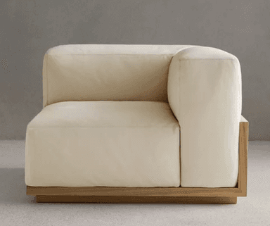 A modern modular corner armchair with a light cream upholstered finish and a visible natural wood base, designed to integrate into a larger sectional sofa. — 3D model