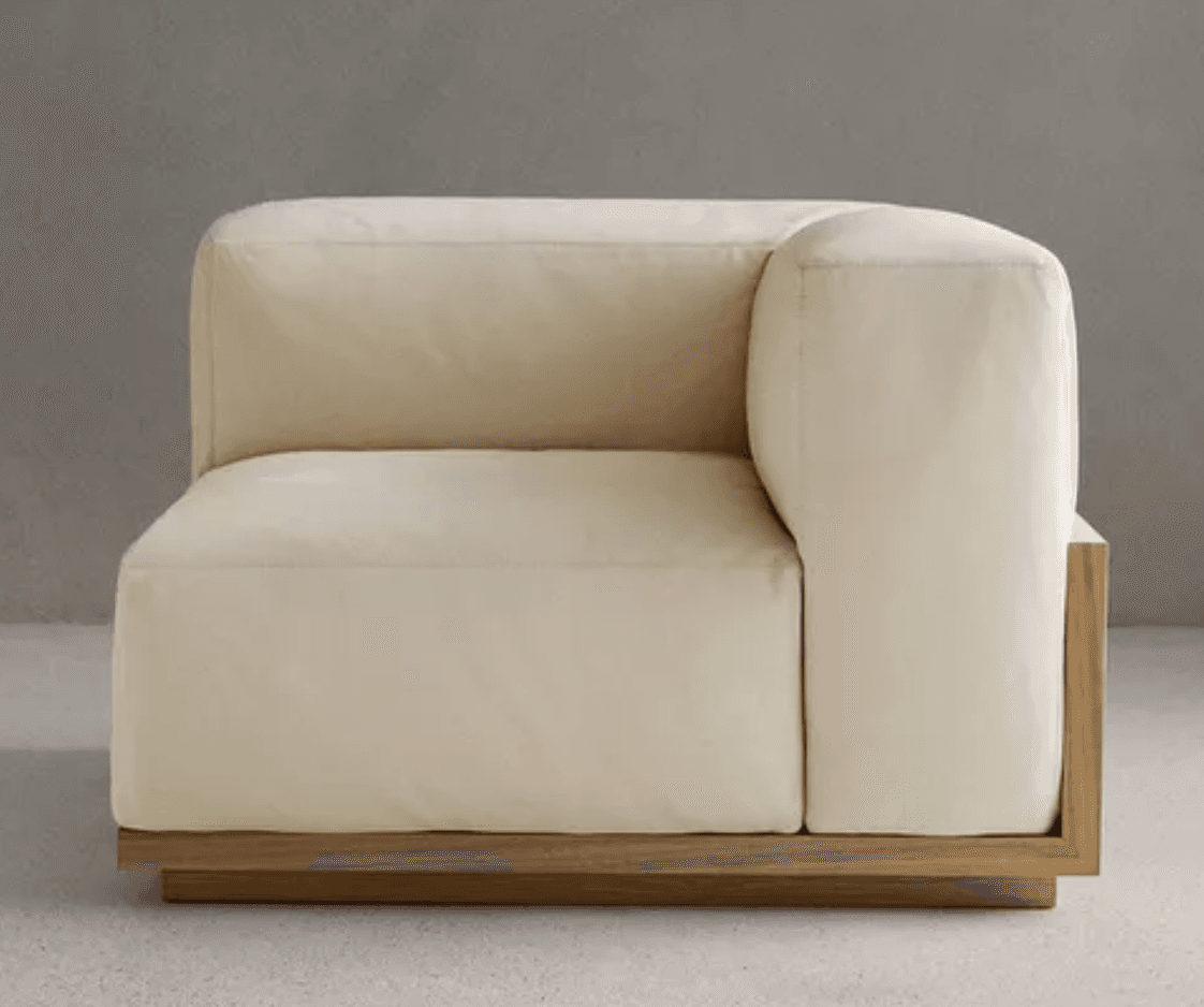 A modern modular corner armchair with a light cream upholstered finish and a visible natural wood base, designed to integrate into a larger sectional sofa. — 3D model