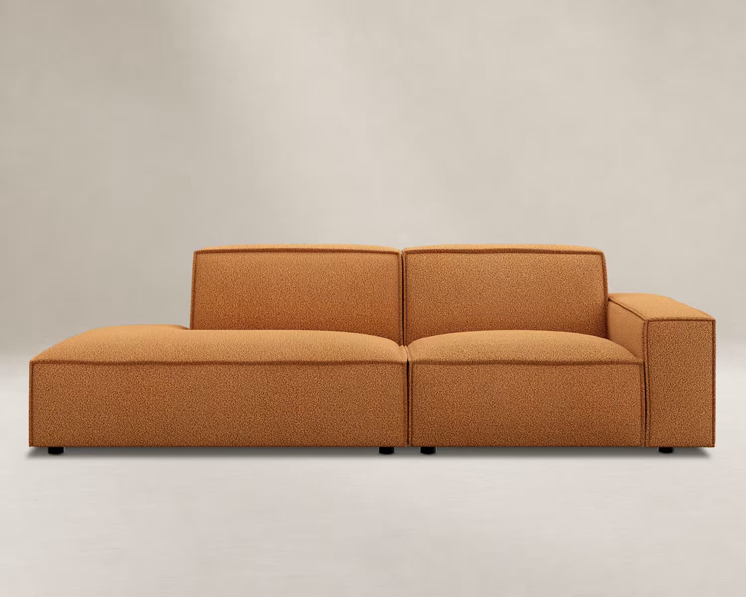A modern modular sectional sofa featuring an L-shaped configuration with a left-hand chaise lounge and a right-hand armrest. It is upholstered in a warm orange, textured fabric with clean, blocky lines and rests on low-profile black feet. — 3D model