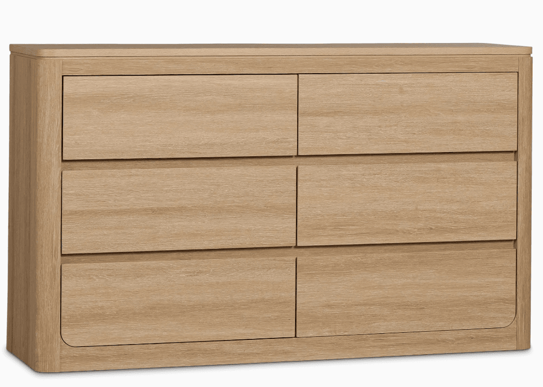 A dresser with six drawers arranged in two columns of three. The dresser has a light wood grain finish and rounded edges on the sides and the top surface. It appears to be a freestanding unit. — 3D model