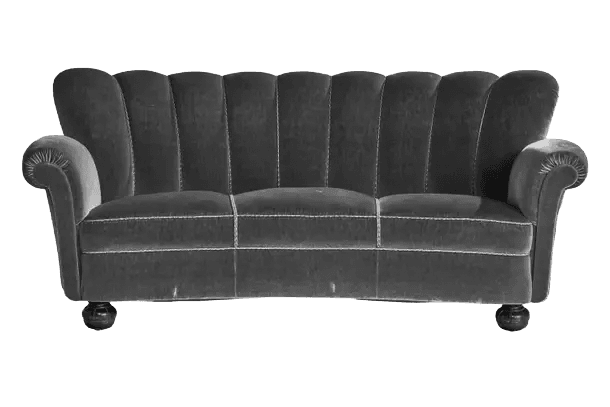 A curved, three-seater sofa upholstered in dark grey velvet. The backrest features a distinctive fluted or channeled design with vertical seams creating segmented panels. The sofa has rolled arms and is supported by short, dark wooden bun feet. — 3D model