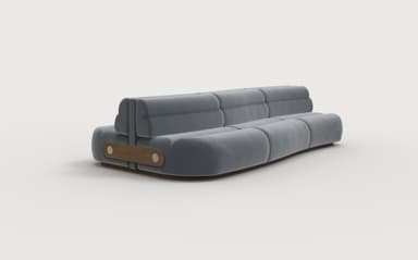 A modern, low-profile sofa with a rounded, modular design. The upholstery appears to be a soft, textured fabric in a muted gray tone. The sofa features deep cushioning with segmented sections on both the seat and the backrest, creating a plush, inviting appearance. The frame is low and appears to be constructed from wood, with a visible wooden accent panel on each end featuring two circular fasteners. The overall aesthetic suggests contemporary design. — 3D model