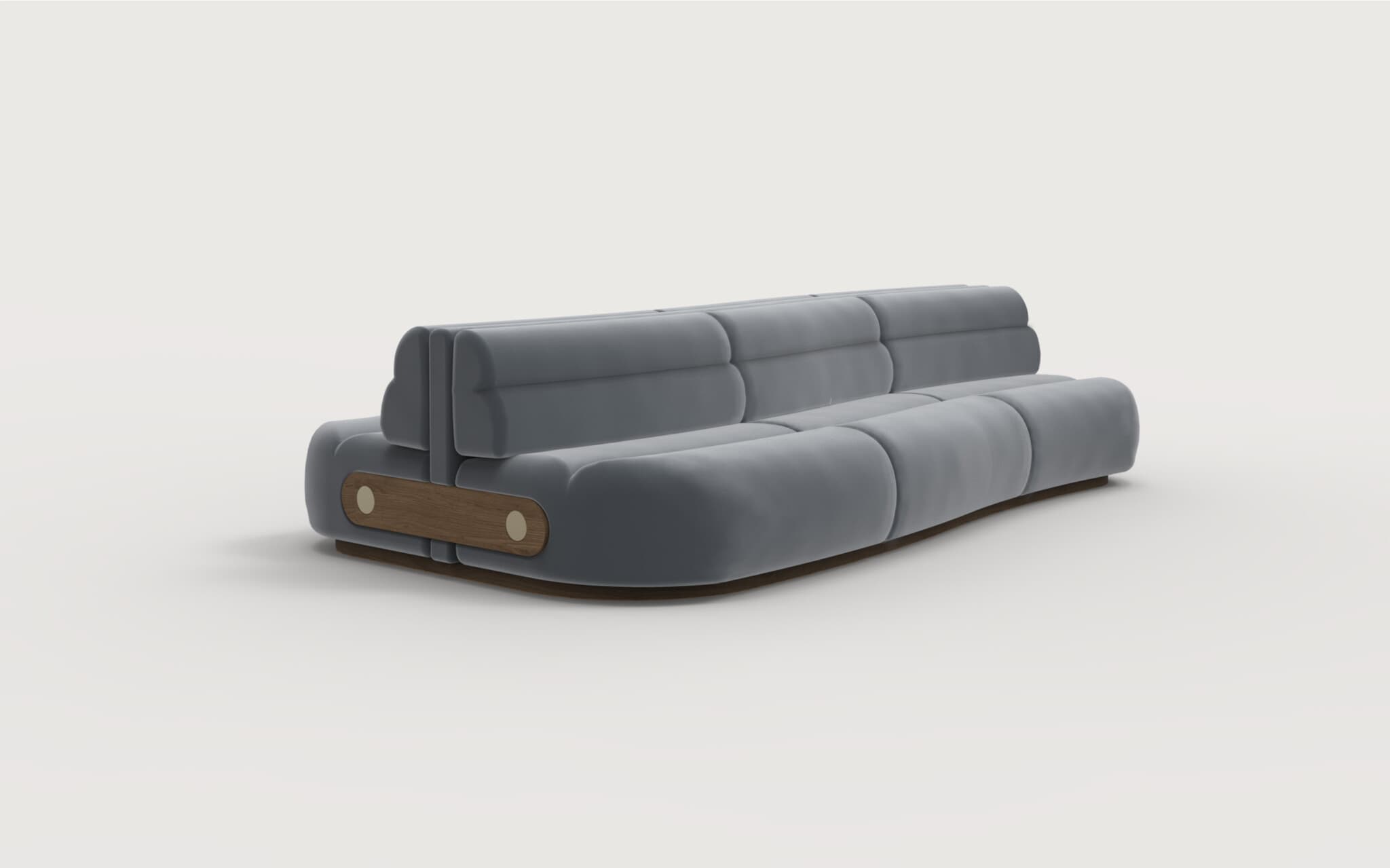 A modern, low-profile sofa with a rounded, modular design. The upholstery appears to be a soft, textured fabric in a muted gray tone. The sofa features deep cushioning with segmented sections on both the seat and the backrest, creating a plush, inviting appearance. The frame is low and appears to be constructed from wood, with a visible wooden accent panel on each end featuring two circular fasteners. The overall aesthetic suggests contemporary design. — 3D model