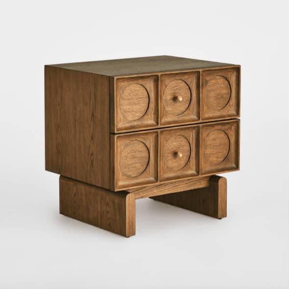A compact wooden chest of drawers with six drawers arranged in two columns and two rows. Each drawer front is recessed within a square frame and features a circular motif with a central brass knob. The piece is supported by a low-profile wooden base with geometric leg elements. — 3D model
