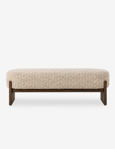 A long, upholstered bench with a textured, boucle-like fabric in a neutral off-white color. The bench features a solid, dark wood frame with a minimalist design. The frame consists of two horizontal pieces connecting the legs, which have a subtle, angled profile. — 3D model