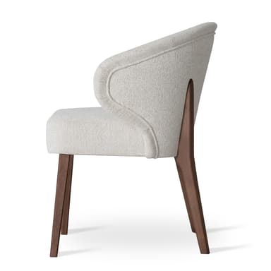 A modern upholstered armchair featuring a curved barrel-back design with integrated armrests and supported by dark wooden legs. The chair is fully upholstered in a light, textured fabric. — 3D model