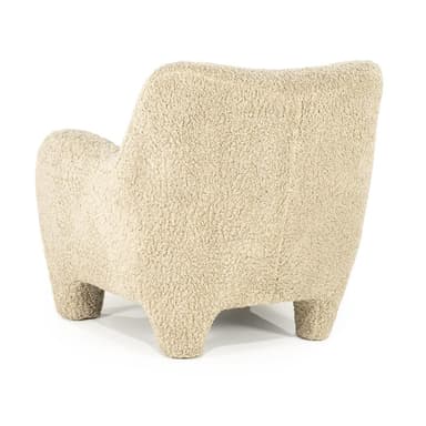 A cream-colored armchair with a rounded silhouette, upholstered in a textured fabric resembling boucle or sherpa. It features broad, enveloping arms, a high back, and four short, chunky legs. A small, square throw pillow with matching upholstery is placed on the seat against the back. — 3D model