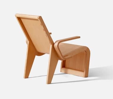 A modernist bent plywood lounge chair with a natural, light wood finish, featuring a reclined backrest and integrated armrests. The chair showcases a continuous, organic form crafted from laminated wood sheets. — 3D model