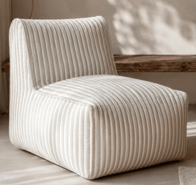 An armless, single-seat upholstered lounge chair featuring a vertical striped pattern in alternating light beige/cream and white. It has a low-profile back integrated with the seat, and a compact, blocky form with softly rounded edges. — 3D model