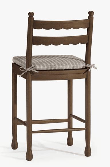 A wooden bar stool with a cushioned seat and two vertical back supports. The seat has a striped fabric pattern. The legs are connected by stretchers for stability. — 3D model