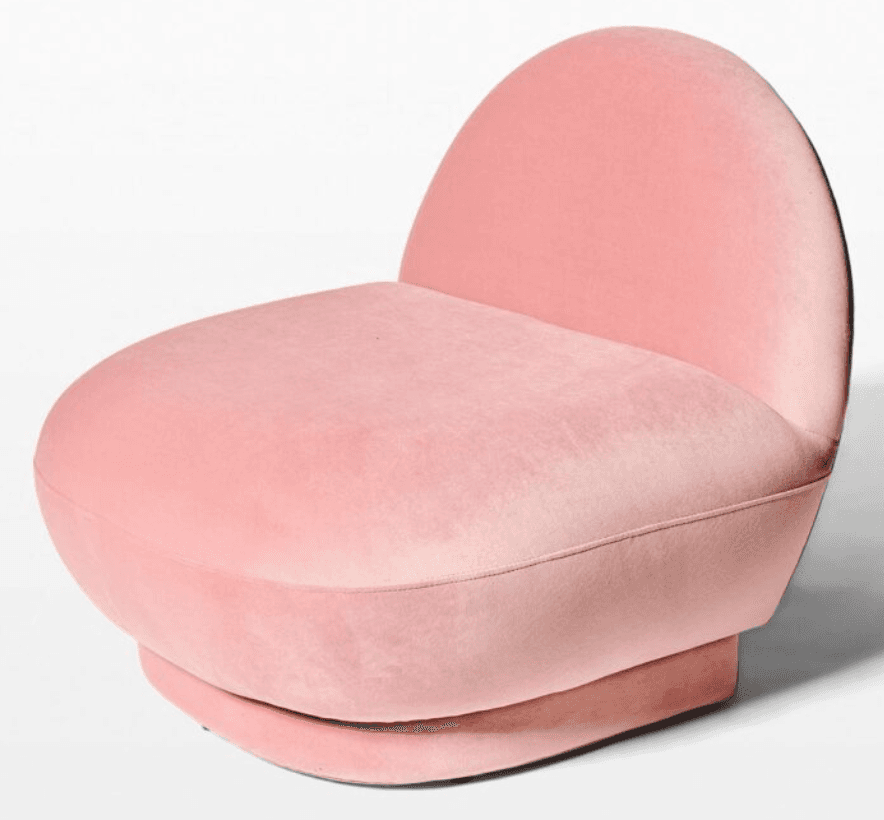 A plush, pink armchair with a rounded, sculptural form. The armchair features a high, curved backrest that seamlessly integrates into the seat. The base is a solid, rounded pedestal. The upholstery appears to be velvet. — 3D model