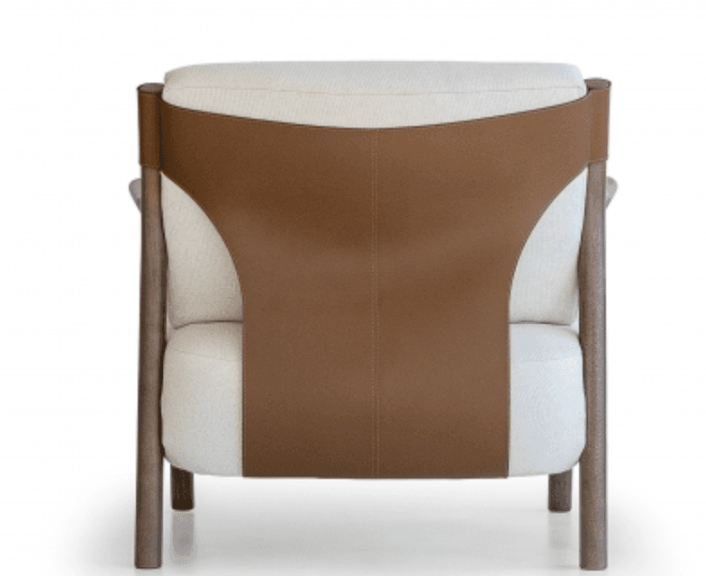 A modern upholstered lounge chair viewed from the back. It features a light-colored fabric on the seat and back cushions, supported by a dark wooden frame. A broad, saddle-brown leather or faux leather strap forms the outer backrest, wrapping around the wooden uprights and secured with visible stitching. The chair appears to be well-constructed with clean lines. — 3D model