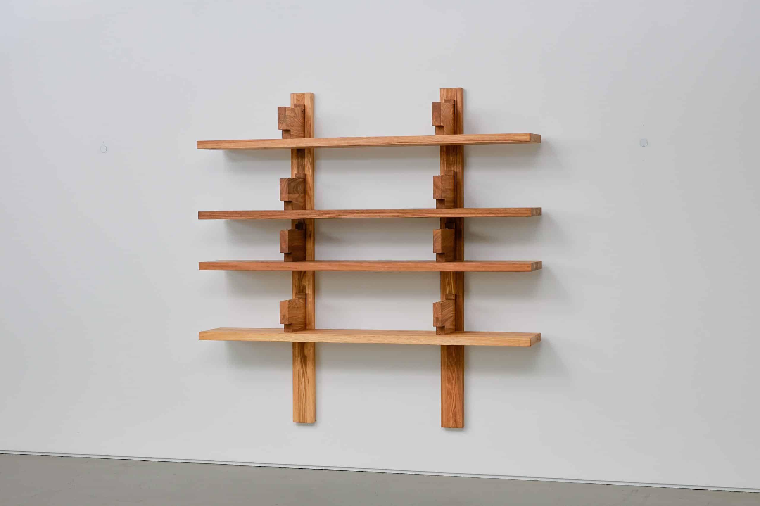 A wall-mounted shelving unit constructed from wood, featuring four horizontal shelves supported by vertical beams and intersecting wooden blocks. The design appears to be modular or cantilevered, with a minimalist aesthetic. — 3D model