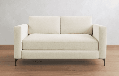 A modern two-seater loveseat featuring a cream or off-white textured fabric upholstery. It has straight track arms, loose back cushions, and a tight seat design. The frame is supported by slender, tapered dark metal legs. The overall aesthetic is clean and contemporary, suitable for various interior styles. — 3D model