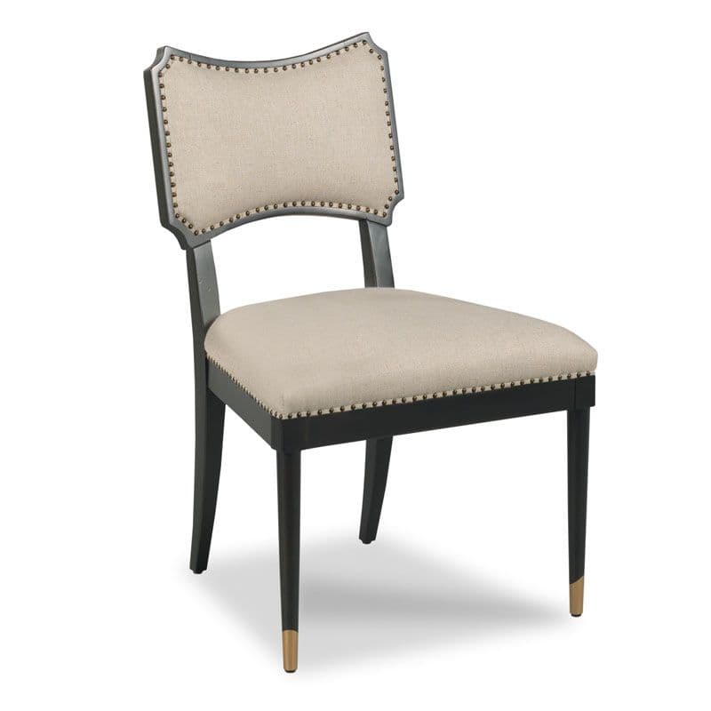 A dark-colored wooden chair with a cushioned seat and backrest. The upholstery is a light beige fabric, secured with decorative nailhead trim around the edges of both the seat and the backrest. The chair back has a distinctive shape with a curved top and angular sides. The legs are dark and slender, with decorative metallic caps on the front legs near the feet. — 3D model