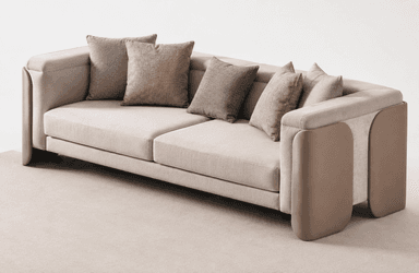 A contemporary two-seat sofa featuring light beige fabric upholstery and distinctive padded armrests. The sofa has a low-profile design with two large seat cushions and multiple loose back cushions in varying shades of brown and beige. The armrests are broad and incorporate a contrasting, rounded, padded panel on the exterior, contributing to its modern aesthetic. — 3D model