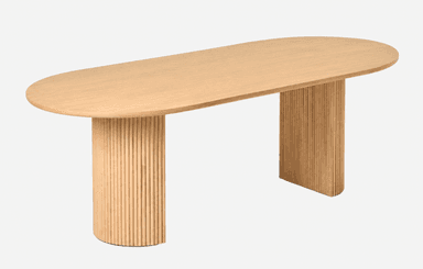 A contemporary light-toned wood table featuring an elongated oval or racetrack-shaped top supported by two substantial semi-cylindrical pedestal bases with vertical fluting. — 3D model