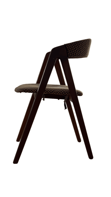 A wooden chair with upholstered seat and backrest. The upholstery features a repeating pattern of small, diamond-shaped motifs in a contrasting color. The frame appears to be made of wood with a dark finish. The chair has a simple, functional design. — 3D model