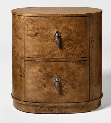 A two-drawer oval nightstand crafted from burl wood veneer, featuring a rich, mottled grain. Each drawer is equipped with a decorative antique silver-toned tassel-shaped pull. The piece has a sleek, rounded silhouette with a flat top and a slightly recessed base. — 3D model