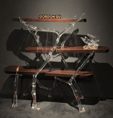 A freestanding multi-tiered display shelf featuring an organic, branch-like polished metal frame and four rectangular wooden shelves. The frame has a fluid, sculptural appearance, supporting the dark-toned display surfaces. — 3D model