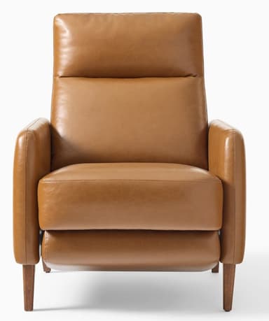 A modern armchair upholstered in a smooth, caramel-colored leather. It features a high backrest with a separate headrest cushion, padded armrests, and a thick seat cushion. The chair is supported by four tapered wooden legs. The overall design suggests a comfortable and stylish piece for a living space. — 3D model
